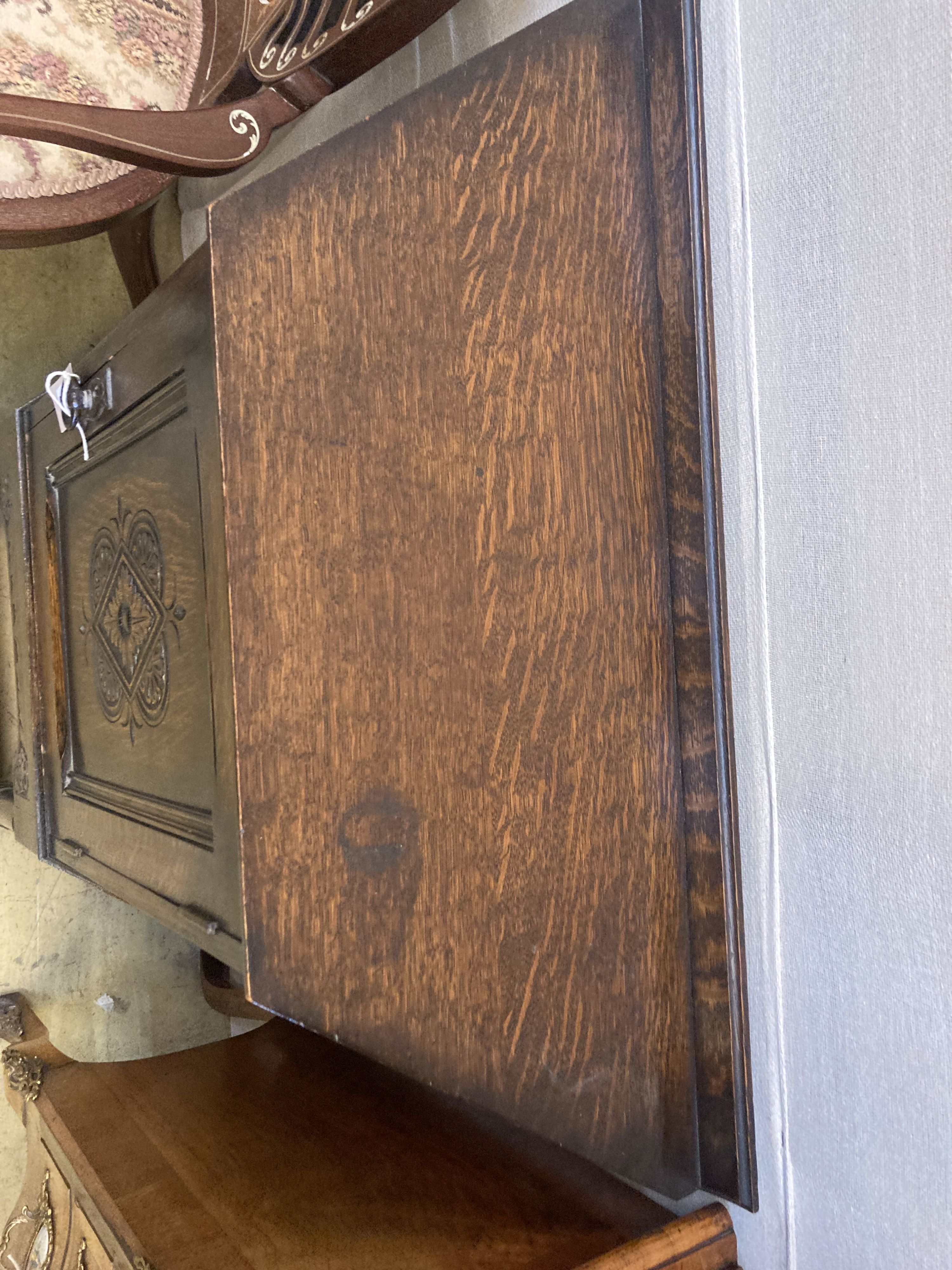 An 18th century style carved oak side cabinet, width 90cm, depth 32cm, height 88cm